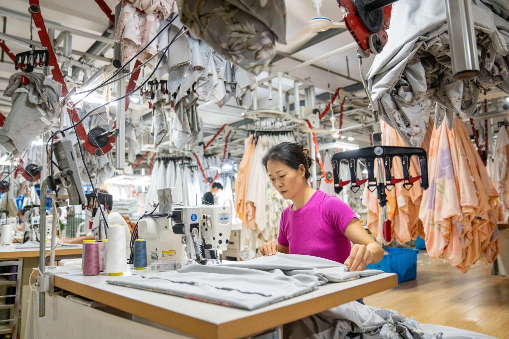 An employee works at a textile factory in Nantong, in eastern Jiangsu province, on June 25. Sentiment towards China’s economy has improved this year amid signs of economic stabilisation and more forceful stimulus measures. Photo: AFP