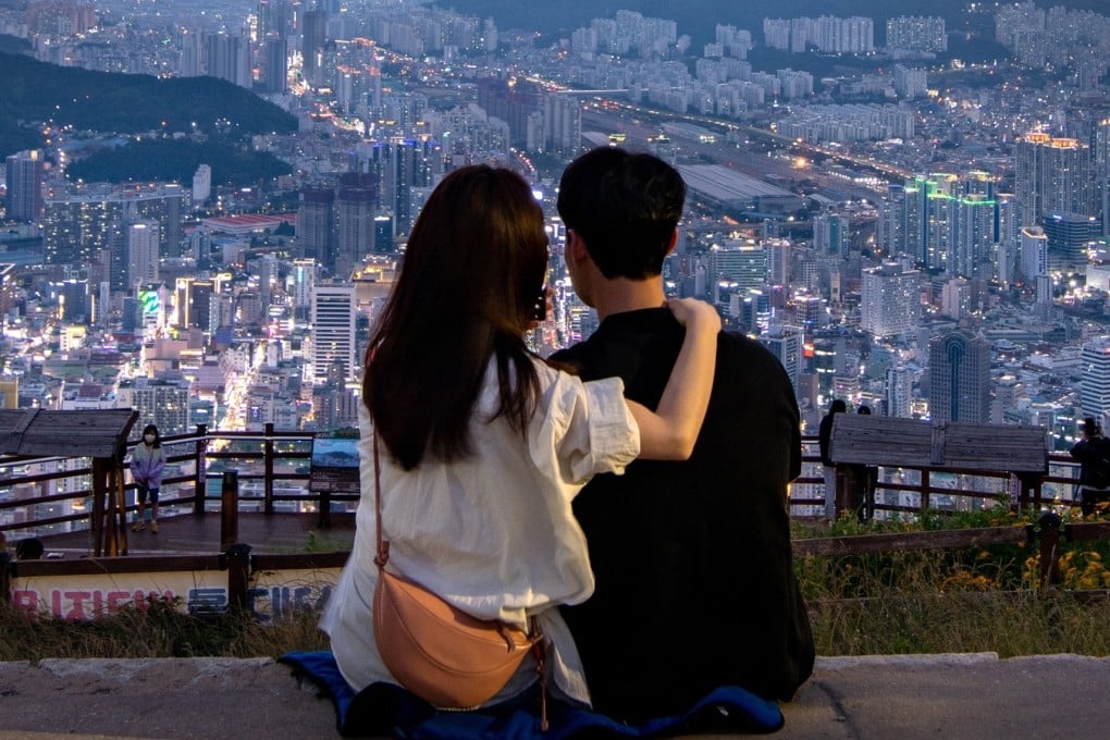 A couple watching the sunset in Busan, South Korea. Photo: Shutterstock