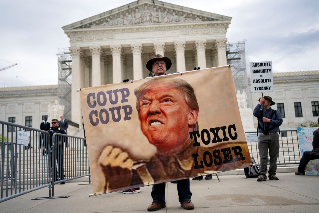A demonstrator holds a sign outside US Supreme Court as justices hear arguments on Donald Trump’s claim of presidential immunity over criminal charges over his efforts to overturn the 2020 presidential election results in Washington on April 25. Photo: Reuters