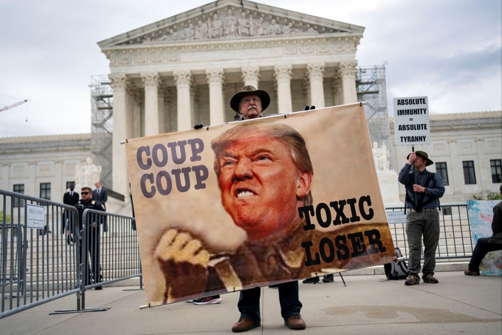 A demonstrator holds a sign outside US Supreme Court as justices hear arguments on Donald Trump’s claim of presidential immunity over criminal charges over his efforts to overturn the 2020 presidential election results in Washington on April 25. Photo: Reuters