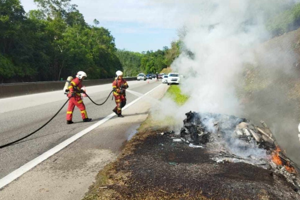 Firefighters extinguish a blaze that fully engulfed a Lamborghini on a highway in Malaysia. Photo: Facebook/BombaBentong