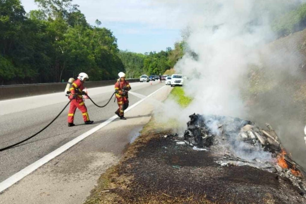Firefighters extinguish a blaze that fully engulfed a Lamborghini on a highway in Malaysia. Photo: Facebook/BombaBentong
