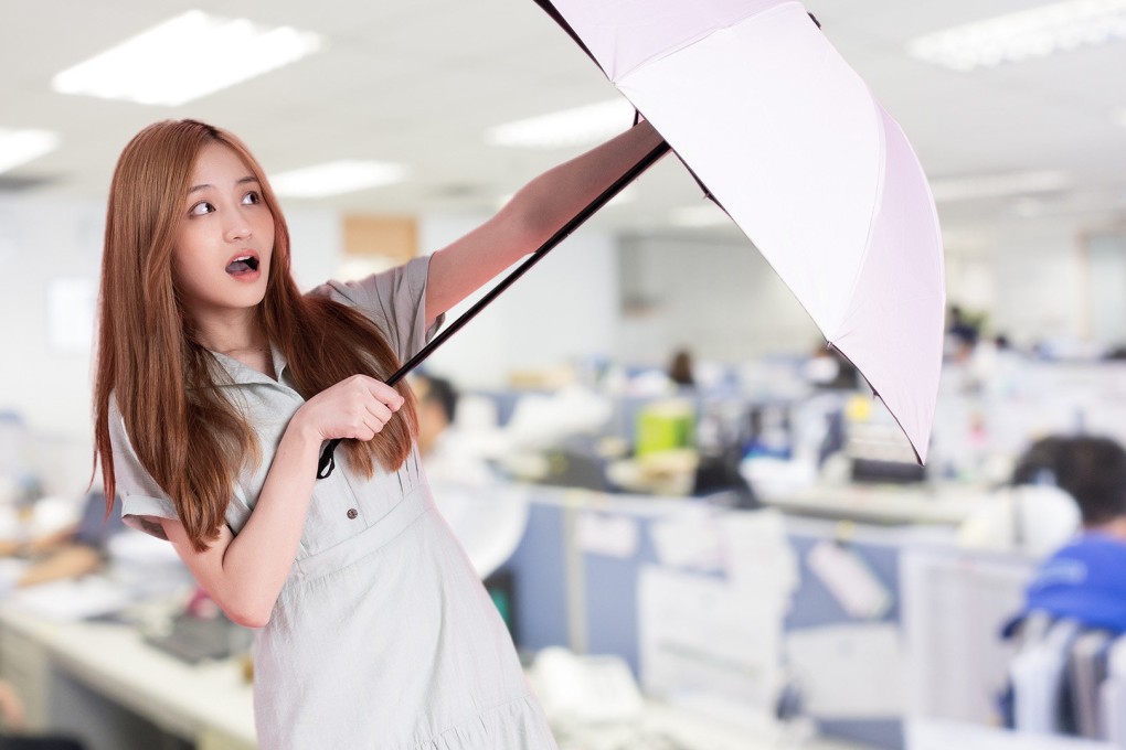 Corporate management complained that the woman used umbrellas to hide her desk from supervisors.
Photo: SCMP composite/Shutterstock