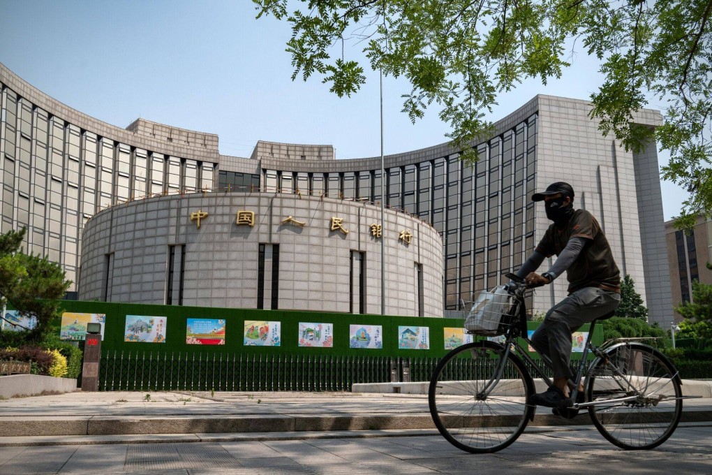 A cyclist rides by the People’s Bank of China in Beijing on May 29. To keep pace with AI integration, central banks might need to collaborate with private banks, while also safeguarding policy discussions with significant economic impacts. Photo: Bloomberg