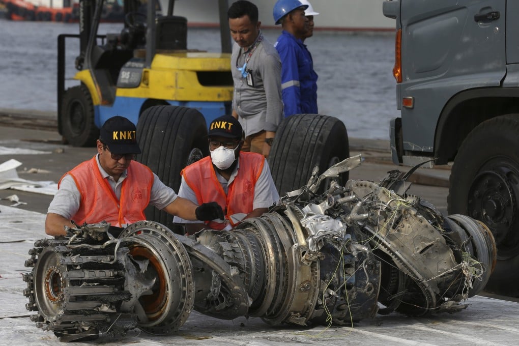 Indonesian officials inspect an engine recovered from the crashed Lion Air jet in 2018. File photo: AP