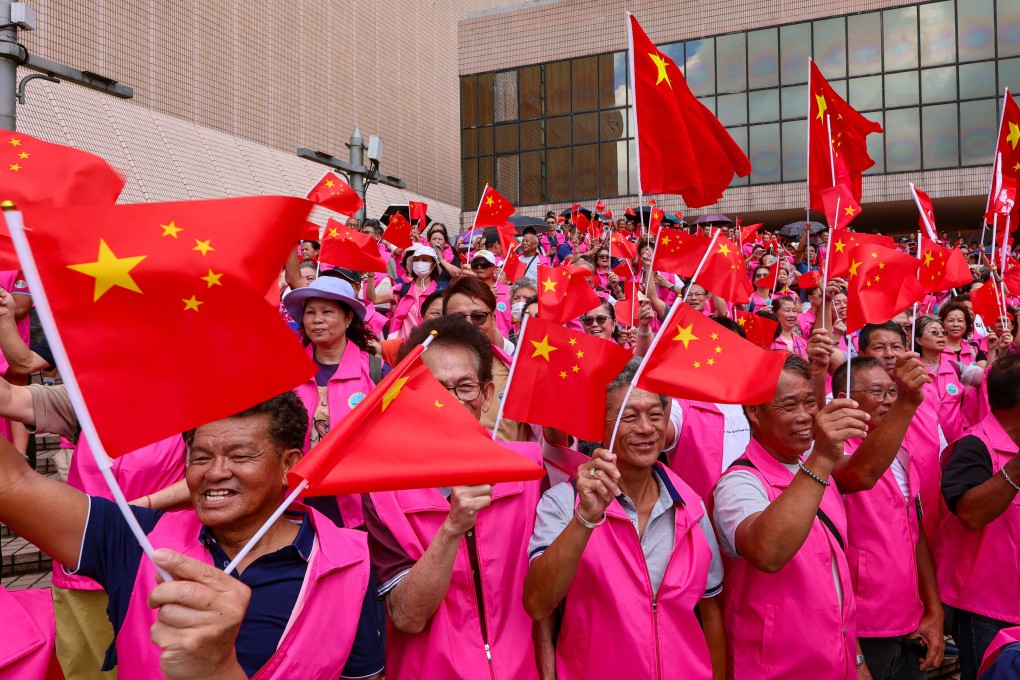Spectators fly the flag at an event in Hong Kong to mark the July 1 anniversary on Monday. Photo: Jelly Tse