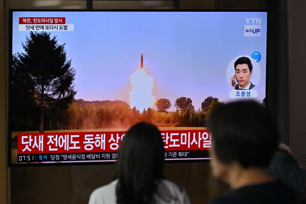 People in Seoul watch a news broadcast with file footage of a North Korean missile test. Photo: AFP