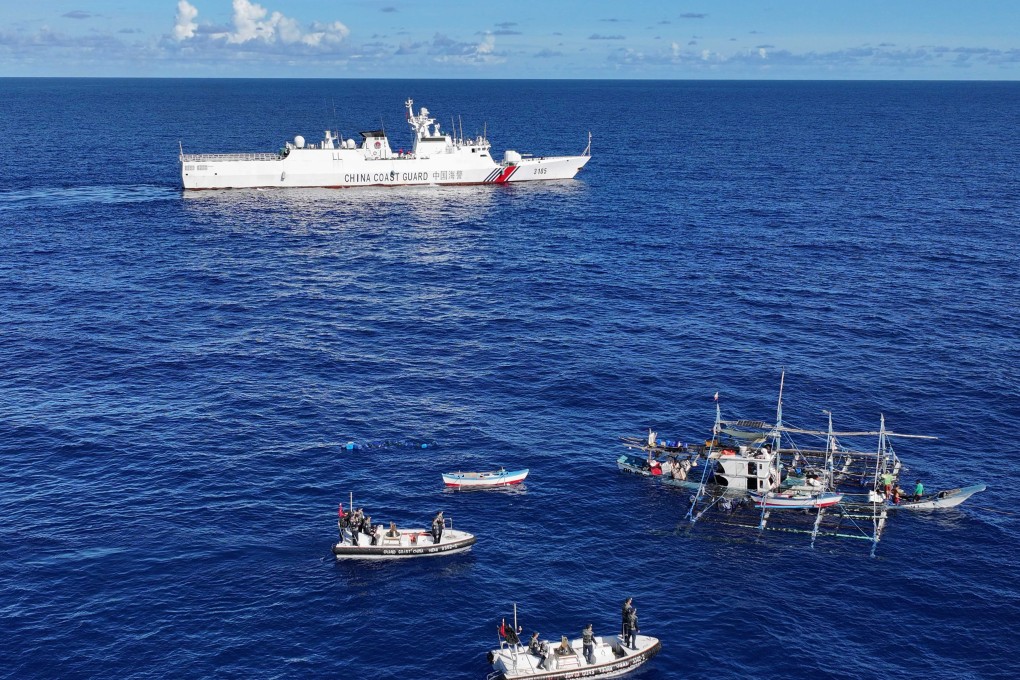 Chinese coastguard vessels seen near the stricken Philippine fishing boat off the disputed Scarborough Shoal in the South China Sea on Saturday. Photo: Xinhua