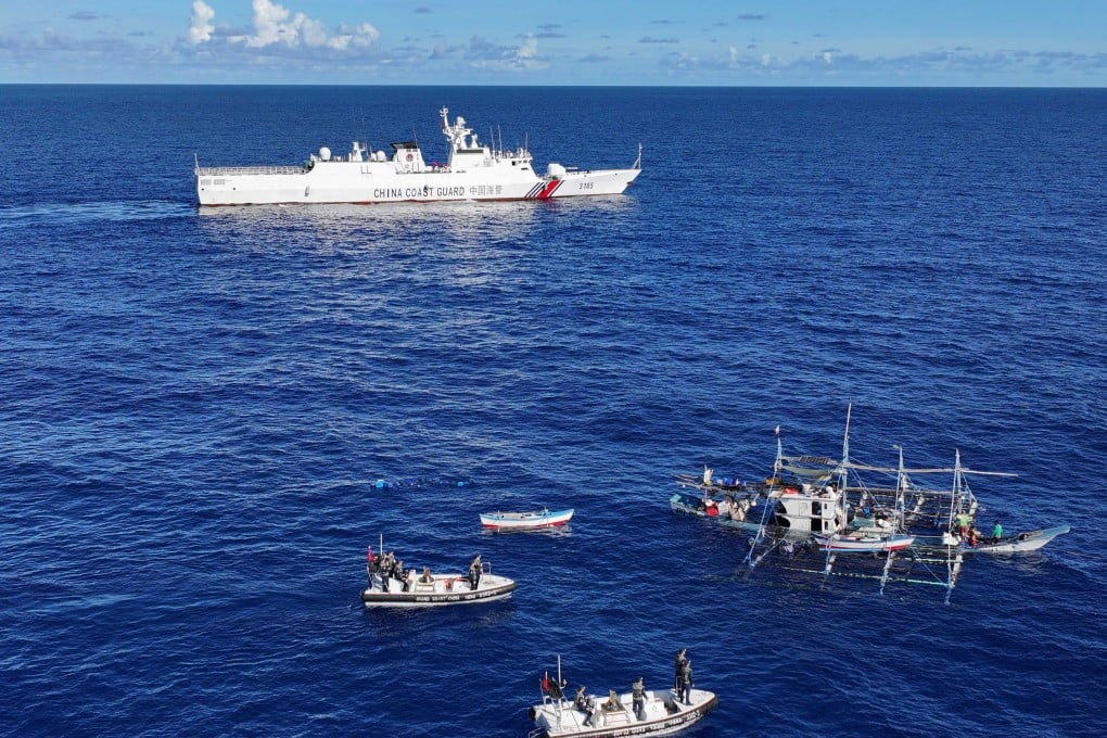 Chinese coastguard vessels seen near the stricken Philippine fishing boat off the disputed Scarborough Shoal in the South China Sea on Saturday. Photo: Xinhua