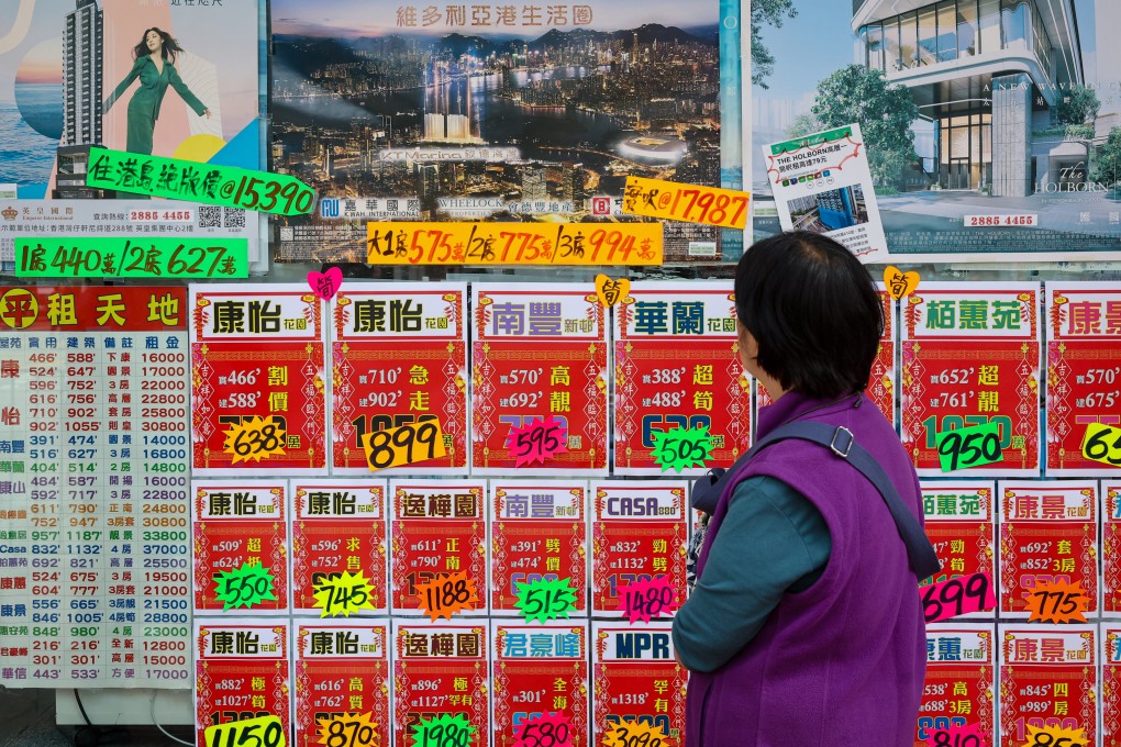 A woman scans residential property advertisements in Quarry Bay. June saw a second straight monthly fall in property transactions after an initial surge that came in the wake of the government’s lifting of restrictions. Photo: Edmond So