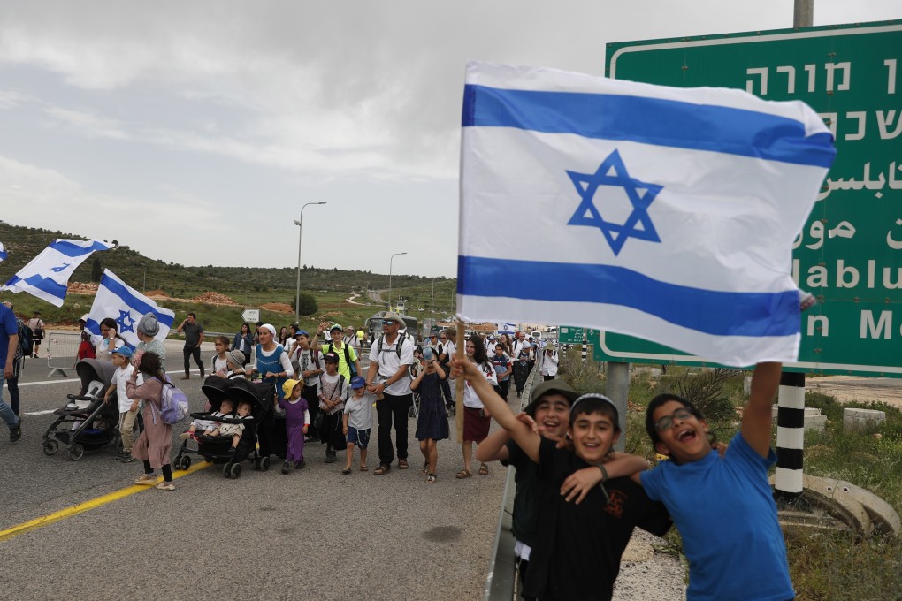 Israeli far-right supporters march near an illegal outpost near the West Bank city of Nablus, in April 2023. Palestinians say they are restricted by Israeli settlers from land and face harassment, intimidation and violence. Photo: EPA-EFE