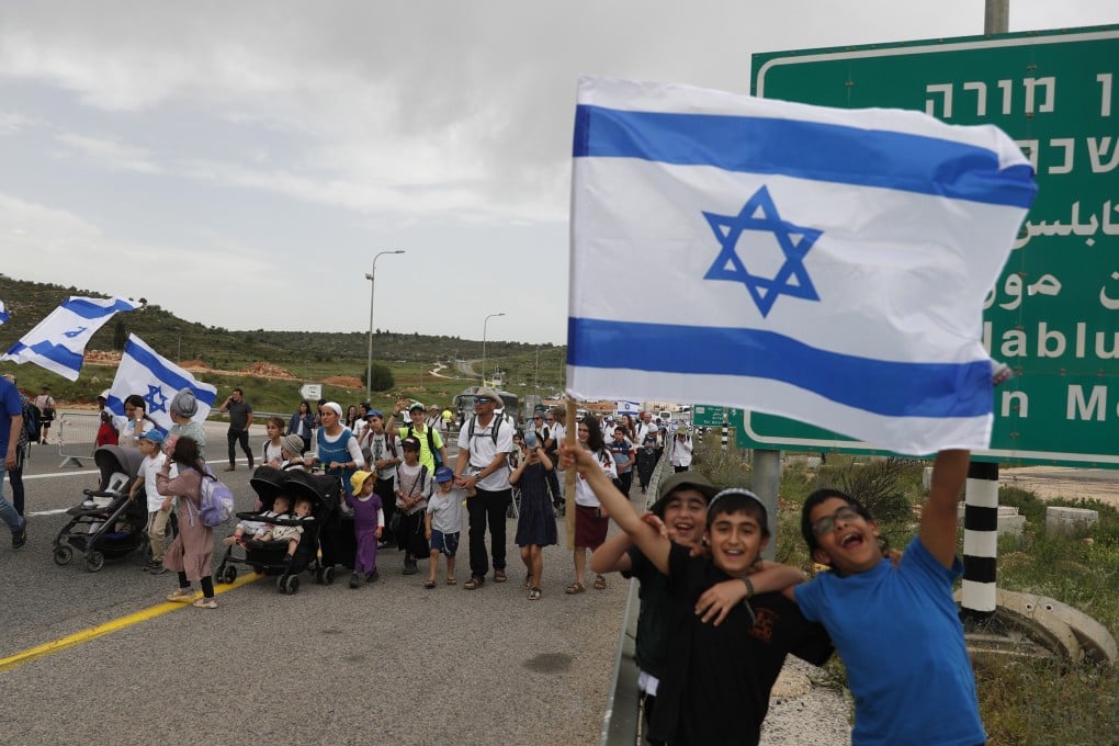 Israeli far-right supporters march near an illegal outpost near the West Bank city of Nablus, in April 2023. Palestinians say they are restricted by Israeli settlers from land and face harassment, intimidation and violence. Photo: EPA-EFE