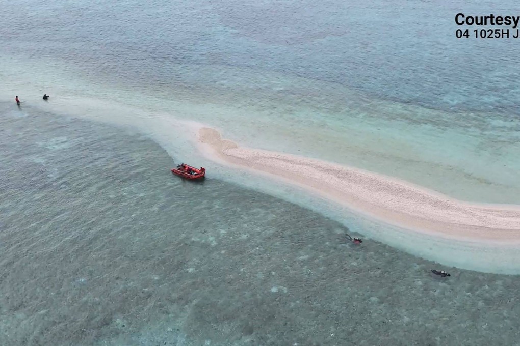 A video screengrab shows Philippine Coast Guard divers and marine scientists surveying part of Sabina Shoal in the waters of the South China Sea on June 7. Photo: Philippine Coast Guard / AFP