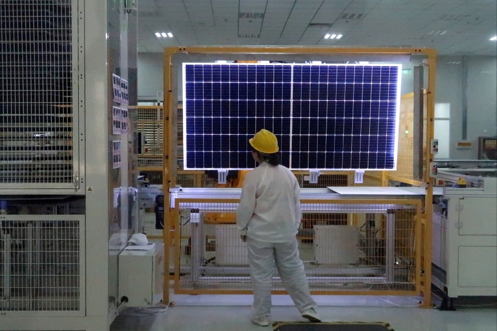 A worker conducts quality-check of a solar module product at a factory of a monocrystalline silicon solar equipment manufacturer LONGi Green Technology in Xian. Photo: Reuters