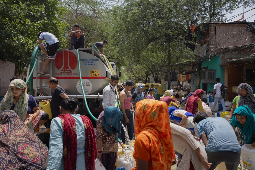 Residents fill up empty water buckets with potable water from the New Delhi Municipal Council water tanker in May in New Delhi, India. Photo: TNS