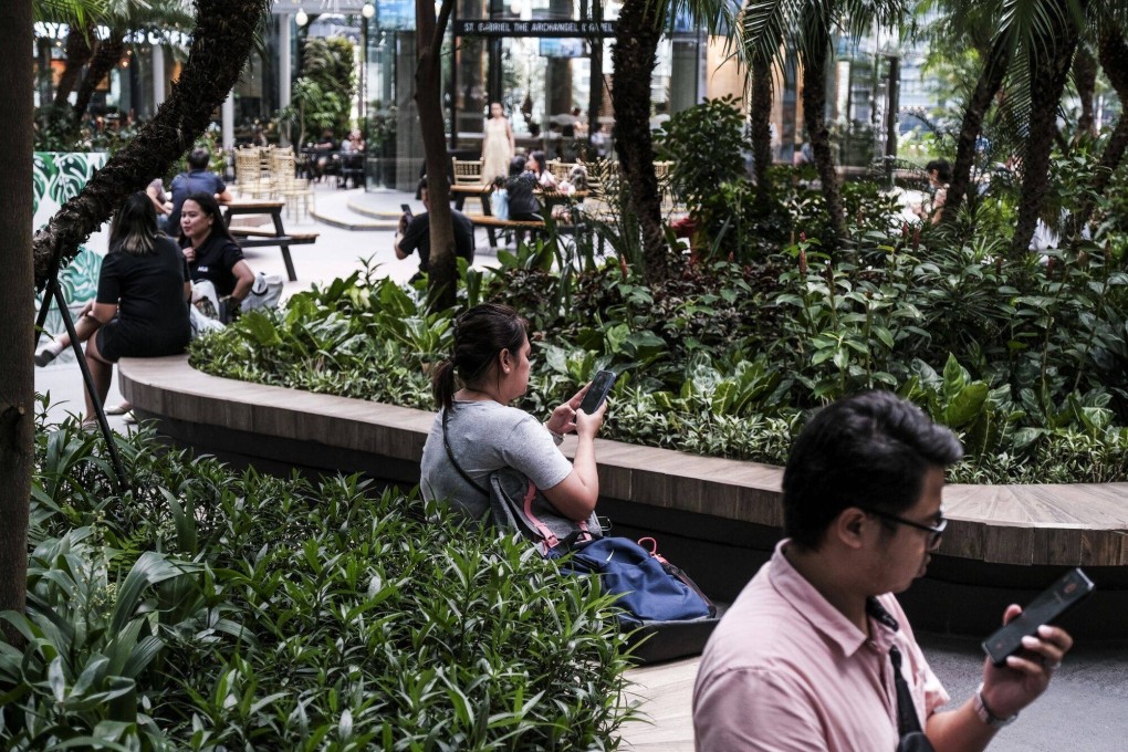 People use mobile phones in Taguig City, the Philippines. Photo: Bloomberg