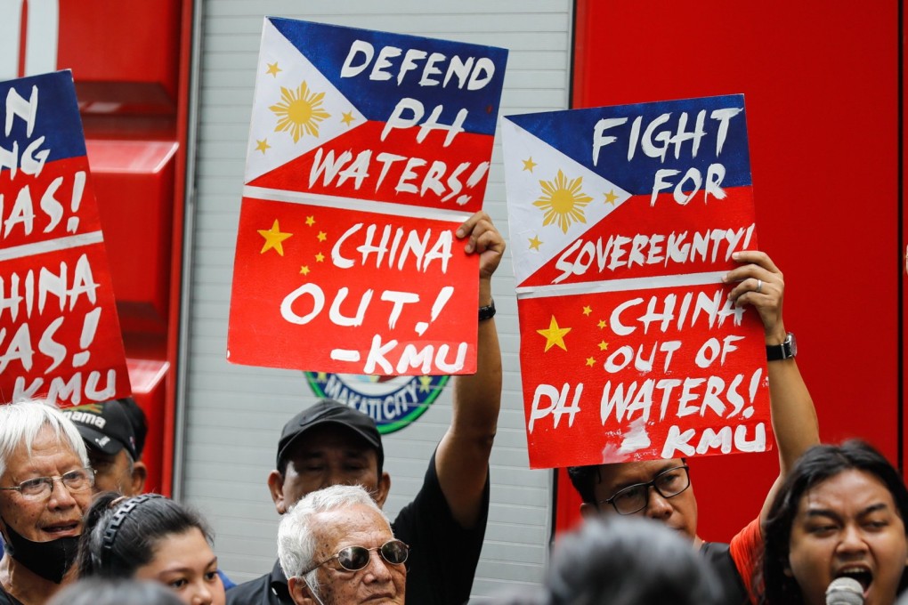 An Filipino protester holds a sign during an anti-China rally outside China’s consular office in Makati City, Philippines, last month. Photo: EPA-EFE