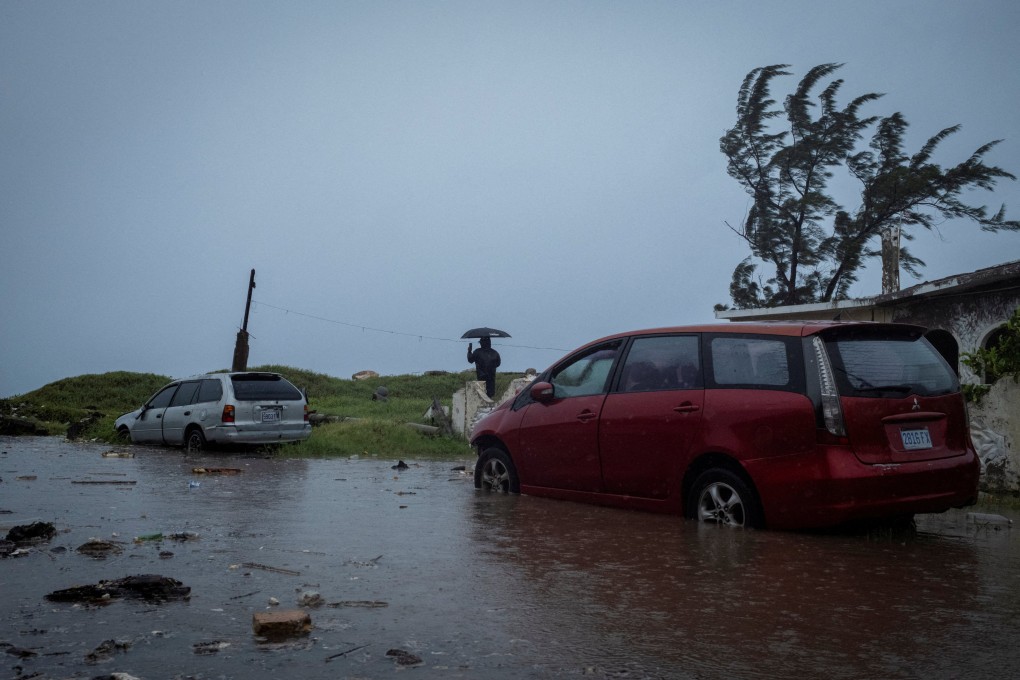 A man looks at breaking waves in the Caribbean Terrace neighbourhood as Hurricane Beryl approaches, in Kingston, Jamaica. Photo: Reuters