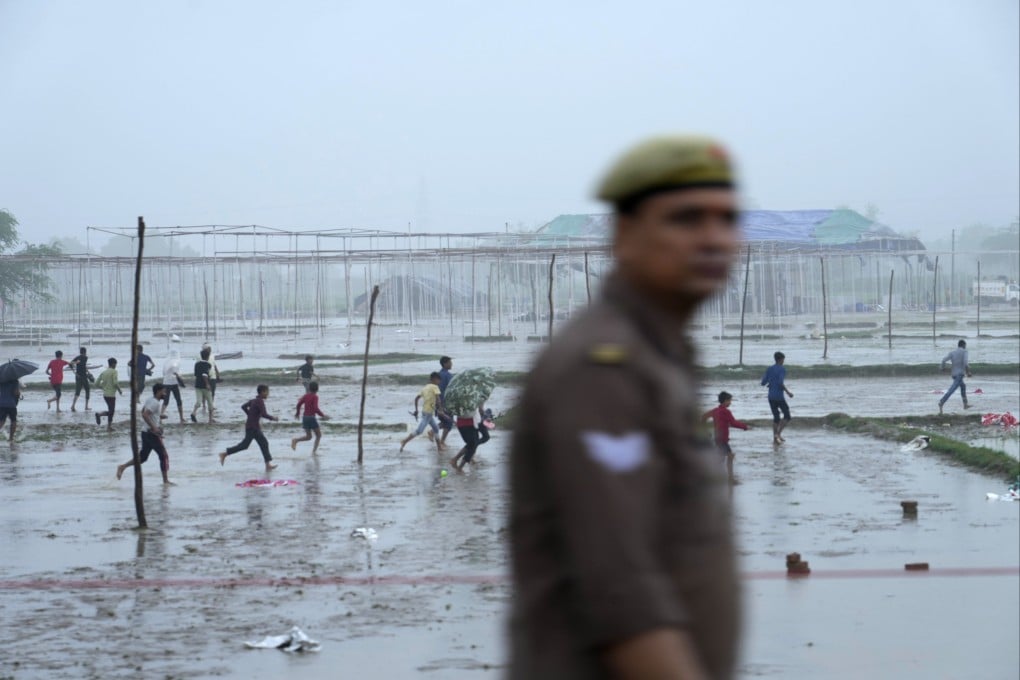 Villagers run past the site of Tuesday’s stampede in Hathras district, Uttar Pradesh. Photo: AP