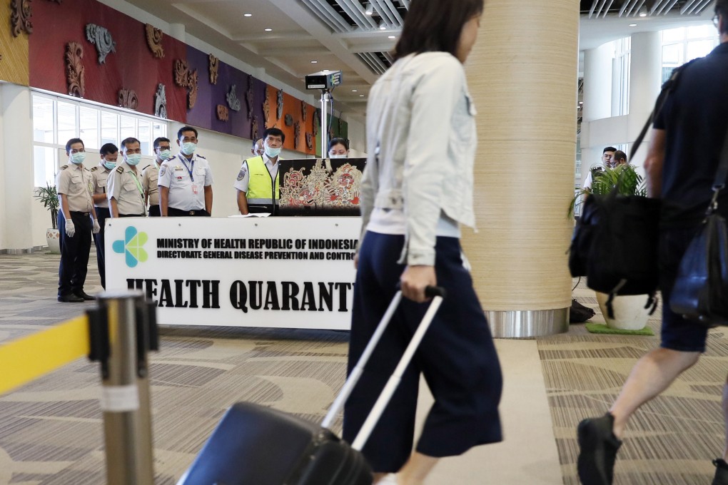 Passengers walk through Bali’s Ngurah Rai International Airport. The hack has paralysed Indonesia’s immigration system, resulting in long queues at airport immigration desks as officers manually check passengers’ passports. Photo: EPA-EFE