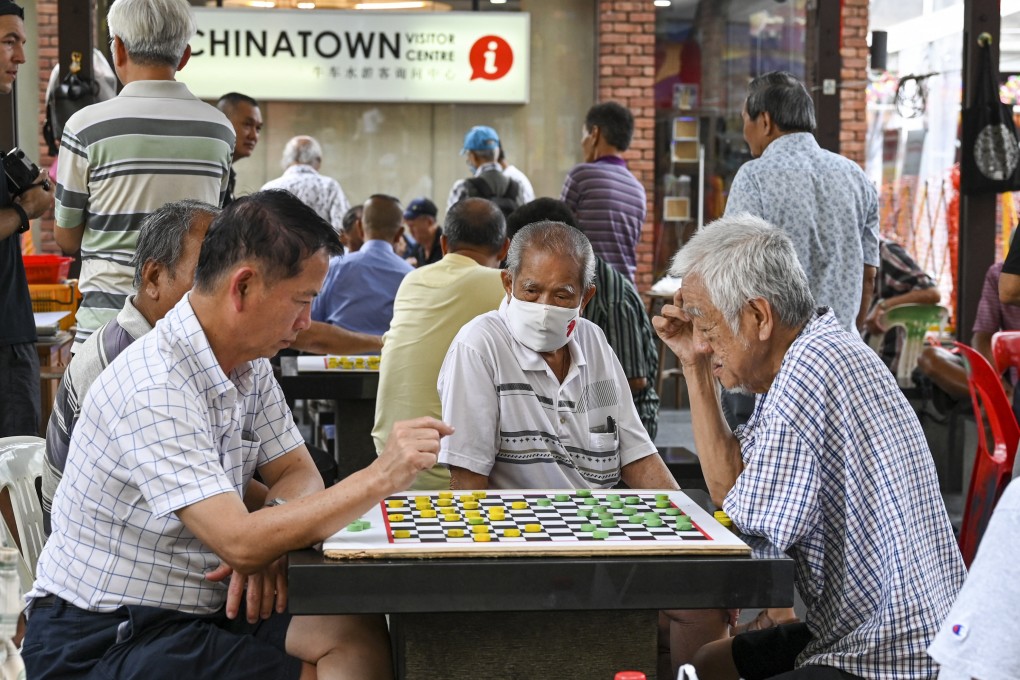 Elderly men play checkers in Singapore’s Chinatown earlier this year. By 2030, around one in four of the city state’s citizens are expected to be 65 or older. Photo: AFP