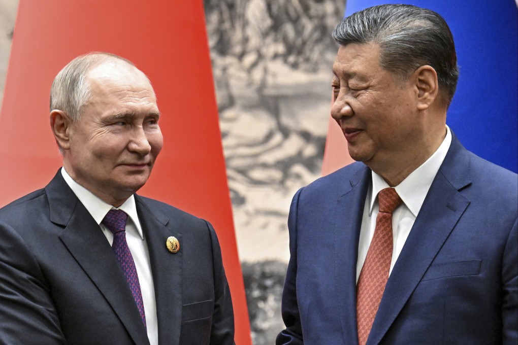 Russian President Vladimir Putin and Chinese President Xi Jinping shake hands prior to their talks in Beijing in May. Photo: Sputnik, Kremlin Pool Photo via AP