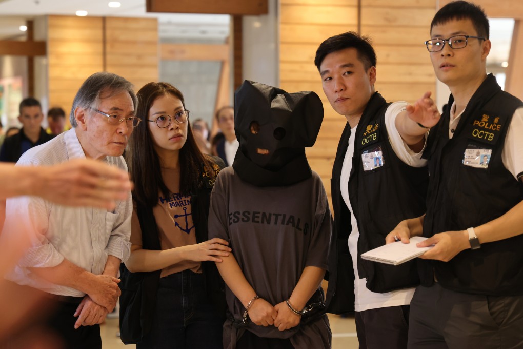 Police officers escort a suspect in connection with the abduction of a three-year-old boy from a Tseung Kwan O shopping centre, allegedly for a ransom of more than HK$5 million. Photo: Jelly Tse