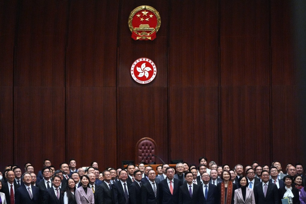 Chief Executive John Lee Ka-chiu and Legislative Council members pose for pictures after passing Article 23 legislation in March. Photo: Eugene Lee