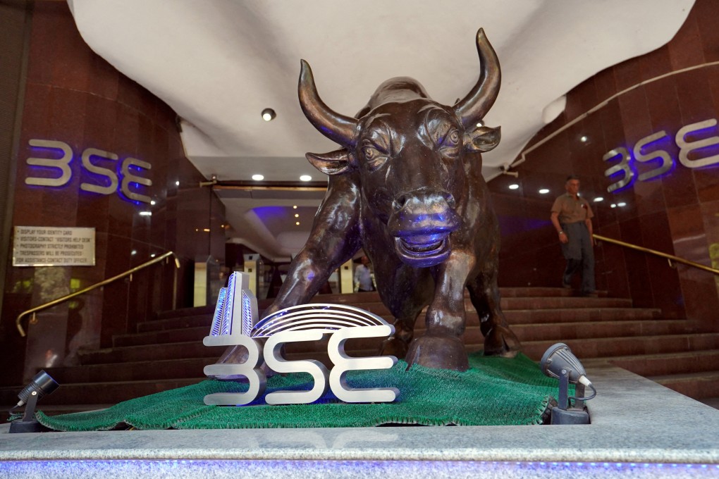 FILE PHOTO: FILE PHOTO: A man walks out of the Bombay Stock Exchange (BSE) building in Mumbai, India, February 28, 2020. REUTERS/Hemanshi Kamani/File Photo/File Photo/File Photo