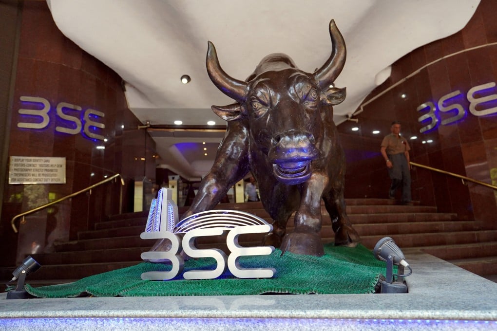 FILE PHOTO: FILE PHOTO: A man walks out of the Bombay Stock Exchange (BSE) building in Mumbai, India, February 28, 2020. REUTERS/Hemanshi Kamani/File Photo/File Photo/File Photo