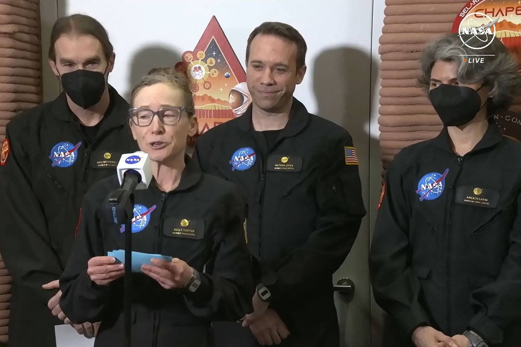 Volunteer crew commander Kelly Haston speaks alongside crewmates (from left) Ross Brockwell, Nathan Jones and Anca Selariu, as they exit the first simulated year-long Mars habitat mission at Johnson Space Centre in Houston, Texas, on Saturday. Photo: Nasa TV via AFP