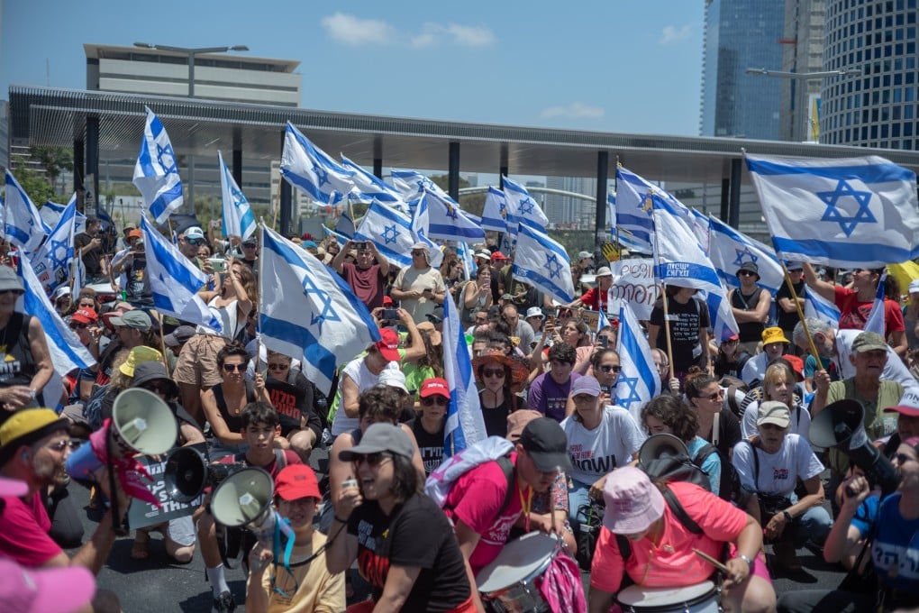 Israeli protesters shout slogans and hold Israeli flags as they gather during a rally in Tel Aviv on Sunday to mark nine months since the Hamas attack on October 7, 2023. Photo: dpa