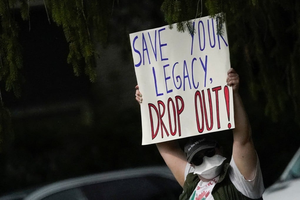 A demonstrator in Madison, Wsiconsin, holds up a sign on the day of a US President Joe Biden’s visit. Photo: Reuters