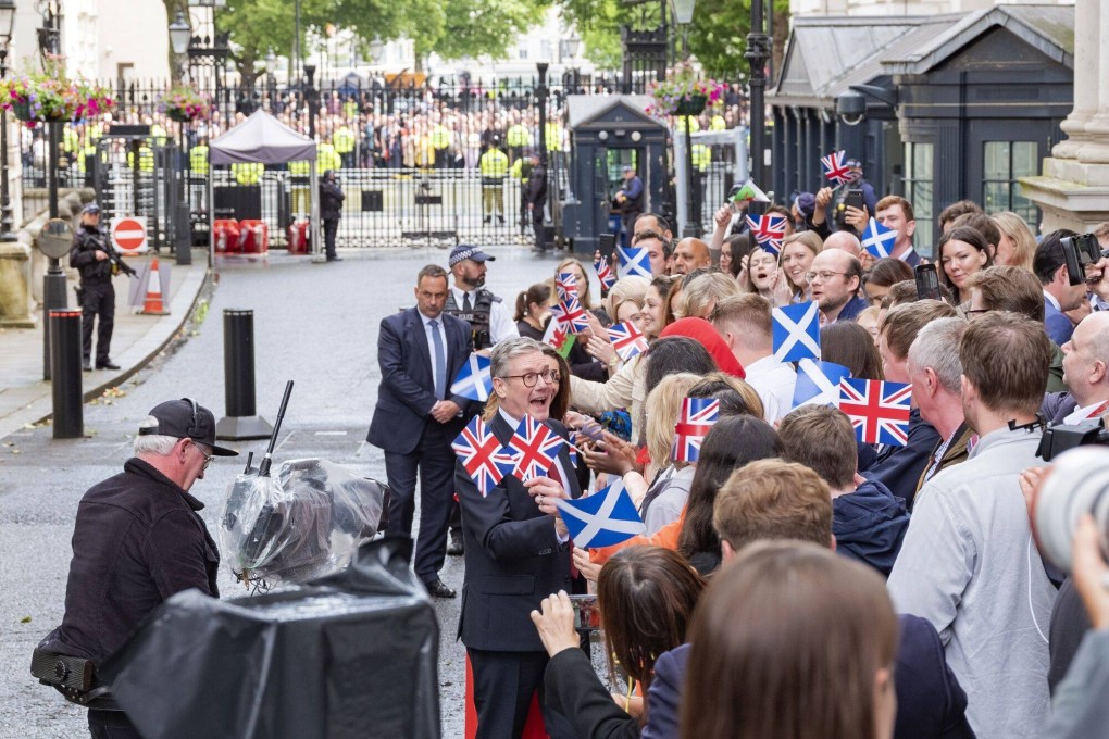 UK Prime Minister Keir Starmer greets supporters in London on July 5 after the Labour Party’s landslide victory which ended 14 years of Conservative rule. Photo: Bloomberg