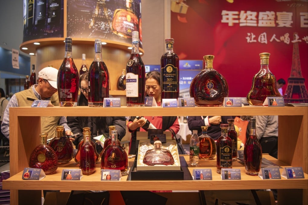 People purchase brandies during the 26th China (Hainan) International the Winter Trade Fair held on December 17, 2023 in Haikou, Hainan Province of China. China’s commerce ministry will hold an anti-dumping hearing involving imports of brandy from the EU next week. Photo: Getty Images