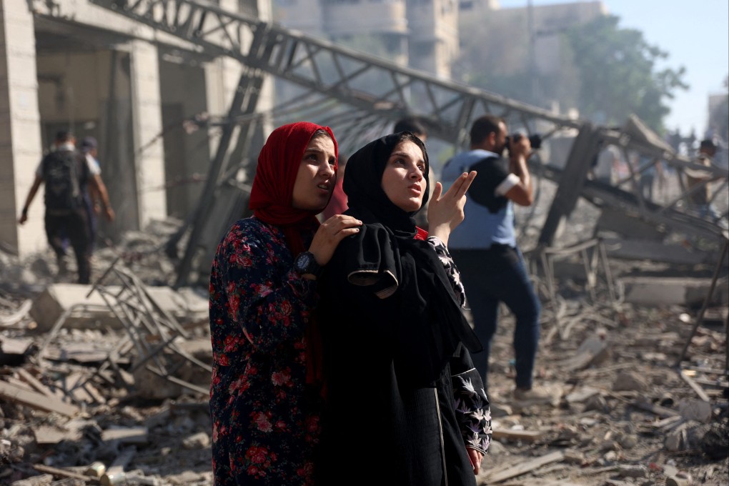 Palestinian women look at the badly damaged Latin Patriarchate Holy Family School after it was hit. Photo: AFP