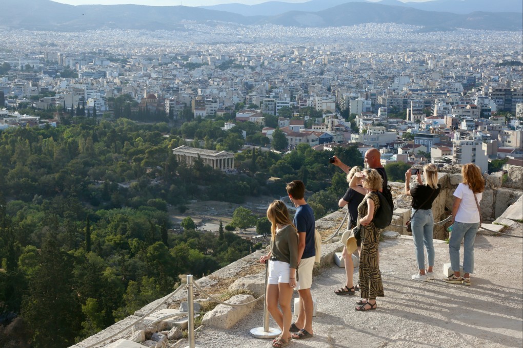Tourists look out over Athens from the Acropolis. The Greek capital has received bad press of late, and it is true that its most famous site does draw big crowds, but a visit reveals the city to be as charming as ever. Photo: Ian Lloyd Neubauer