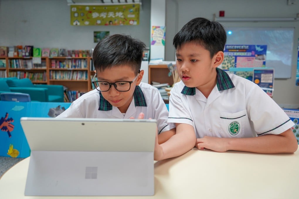 Education University of Hong Kong Jockey Club Primary School students Hoie Tong and Johnny Wong use Microsoft’s AI platform on the company’s Surface computer on July 2, 2024. Photo: Kelly Le