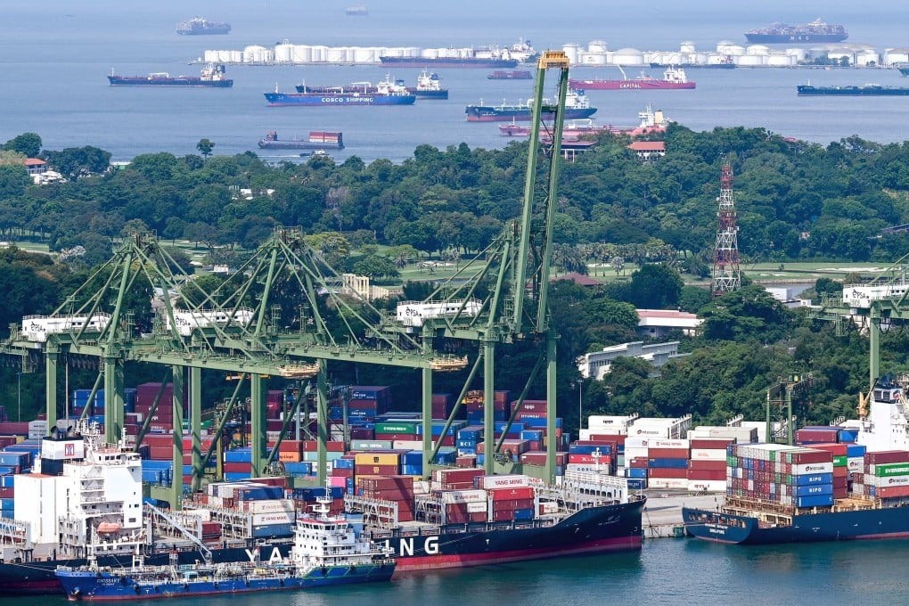Container ships are seen docked next to stacks of containers at a terminal in Singapore earlier this month. The city state’s container ship congestion is spreading to Malaysia. Photo: AFP