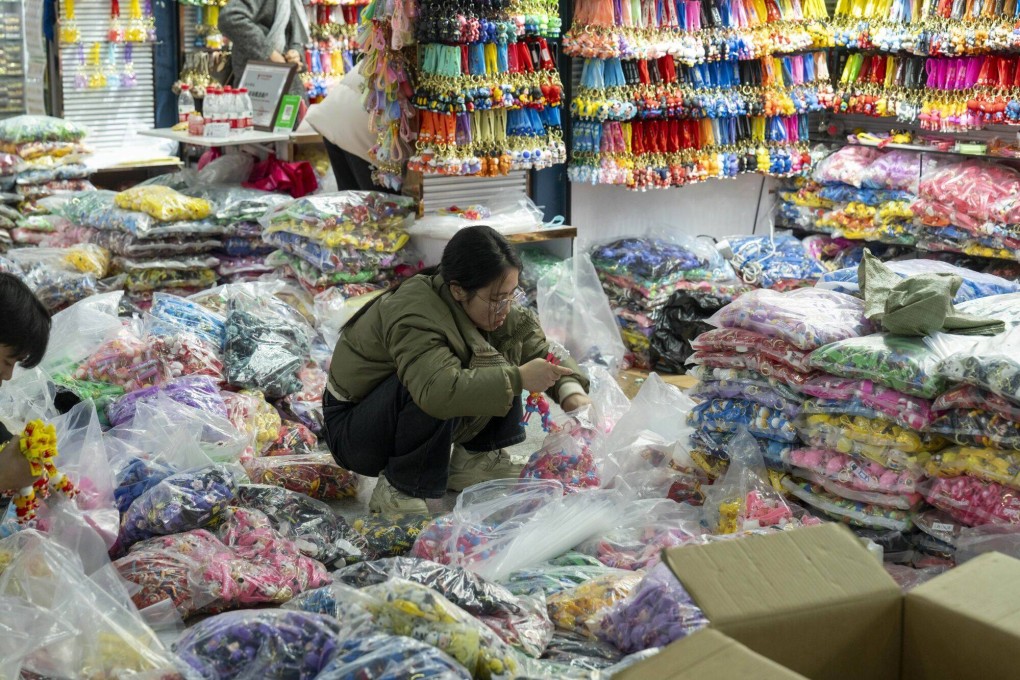 A vendor packs goods in plastic bags to be shipped at the Yiwu International Trade City in Yiwu, China, on March 1, 2024. China’s top leadership has pledged to meet economic targets for the year, avoid risks and maintain social stability, underscoring concern for a recovery hampered by a prolonged property crisis and deflation. Photo: Bloomberg