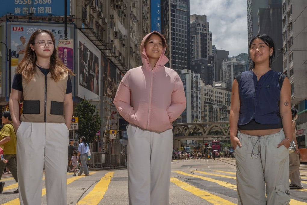 South China Morning Post interns (from left) Annie Cheung, Joanne Yau and Lindsay Feng wear cooling vests and jackets in Causeway Bay, Hong Kong, on July 5, 2024. The latest summer trend, these jackets use fans, ice packs or a combination of both to keep their wearers cool. Photo: Antony Dickson