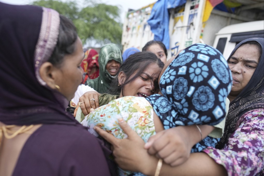 A woman is consoled by relatives after the body of her mother is brought home for cremation after a deadly stampede in the northern Indian state of Uttar Pradesh, on July 3. Photo: AP