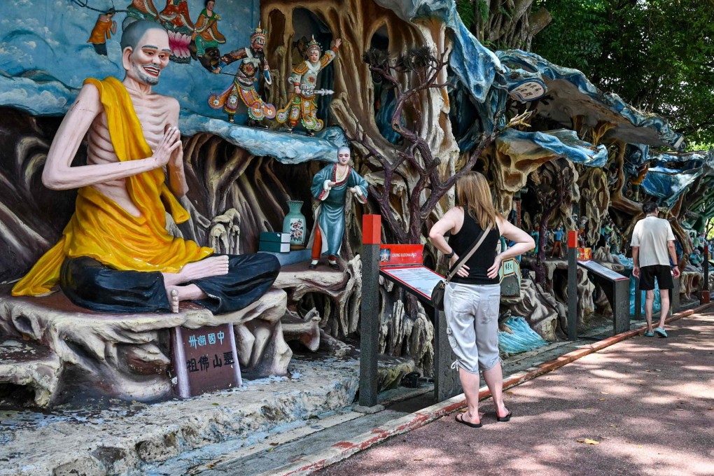 Visitors walking past statues at Haw Par Villa, an Asian cultural park that features Chinese folklore, legend and mythology in Singapore. Photo: AFP