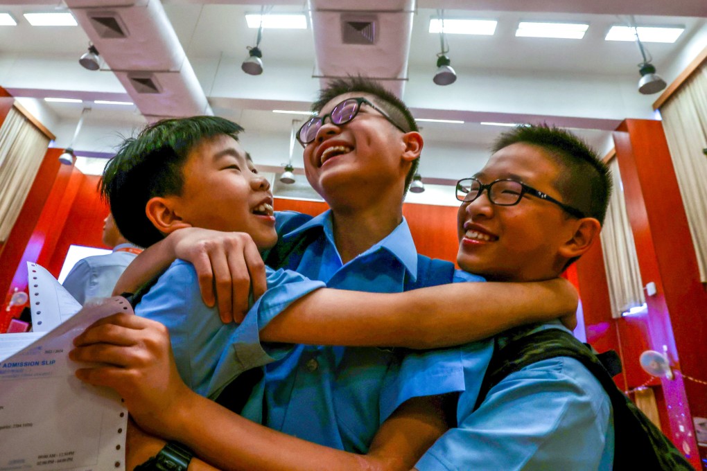 Students (from left) Kardan Ngai, Maximilian Wong and Caspar Wu celebrate their school allocation results. Photo: Jonathan Wong