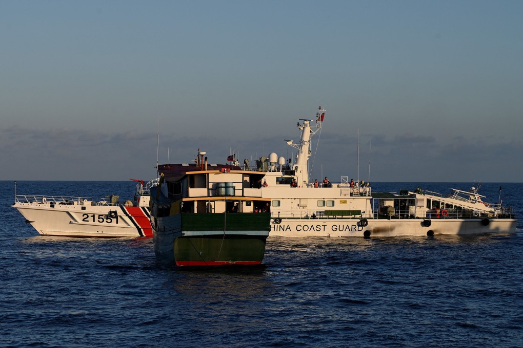 A Chinese coastguard vessel sails near a Philippine boat during a March resupply mission to the Second Thomas Shoal in the disputed South China Sea. Photo: AFP/Getty Images/TNS