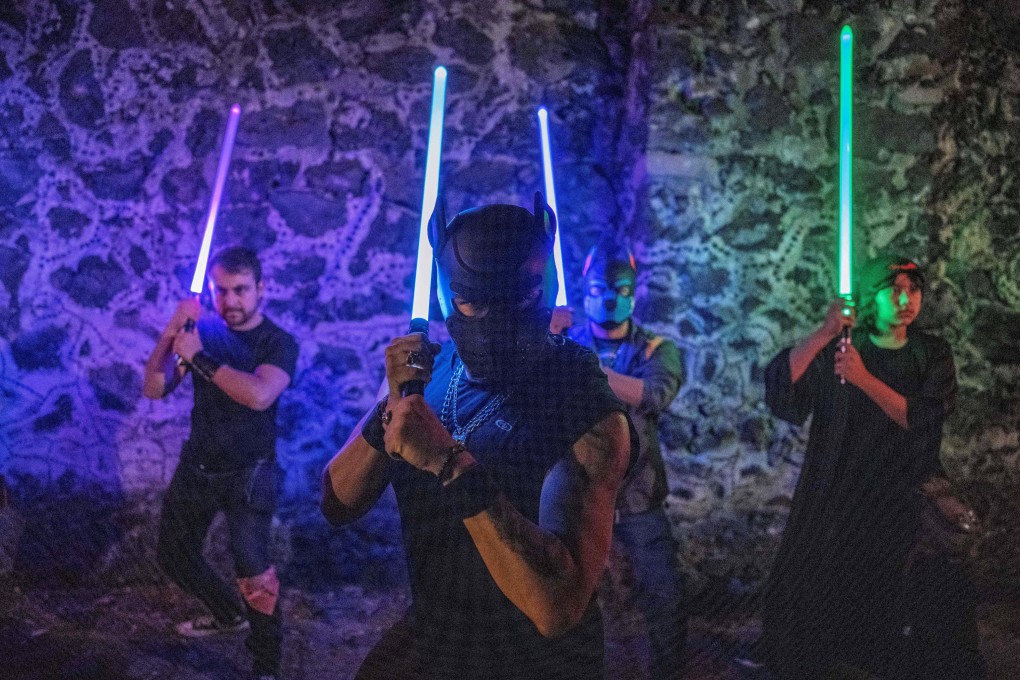 Members of the Jedi Knight Academy (JKAMX) hold lightsabers during training at a park in Mexico City. Photo: AFP