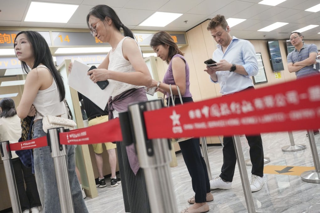 Residents line up at the CTS centre in Sheung Wan to apply for the new mainland China travel permit. Photo: May Tse