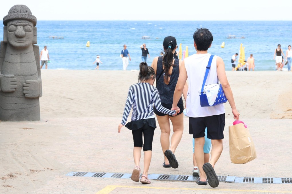 People walk towards a beach on South Korea’s southern resort island of Jeju. Photo: EPA-EFE