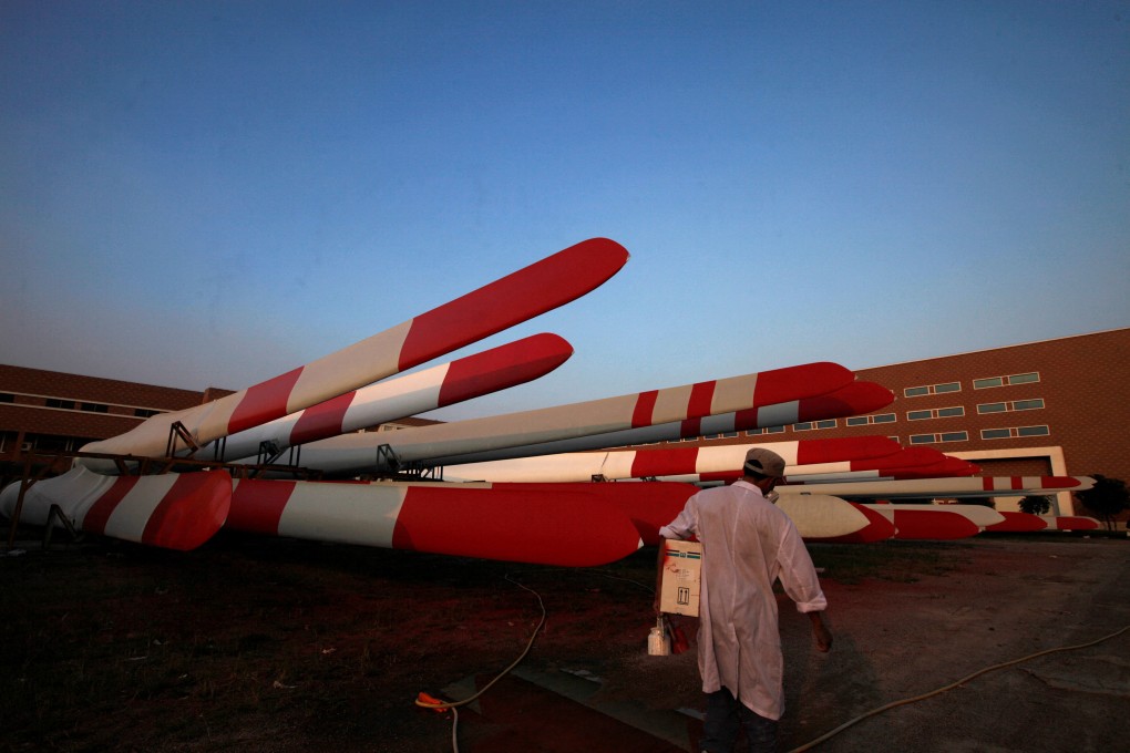 A worker walks past wind turbines at a Ming Yang electric factory in Zhongshan, China. Photo: Reuters