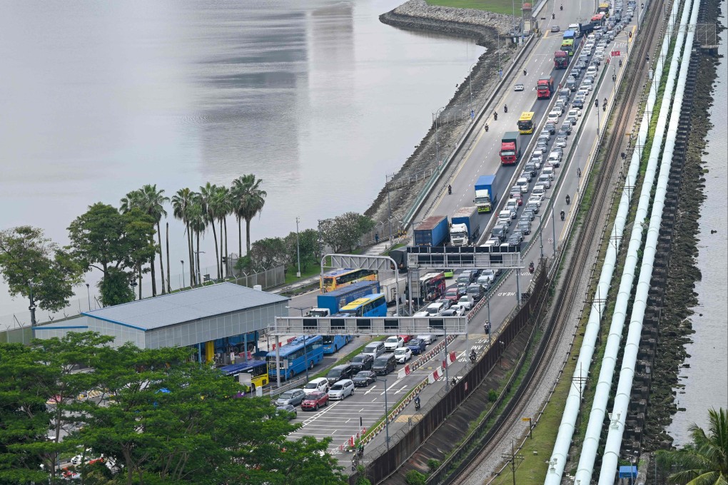 Motorists coming from Malaysia’s state of Johor form a queue as they approach the immigration checkpoint to enter Singapore in March 2023. Photo: AFP